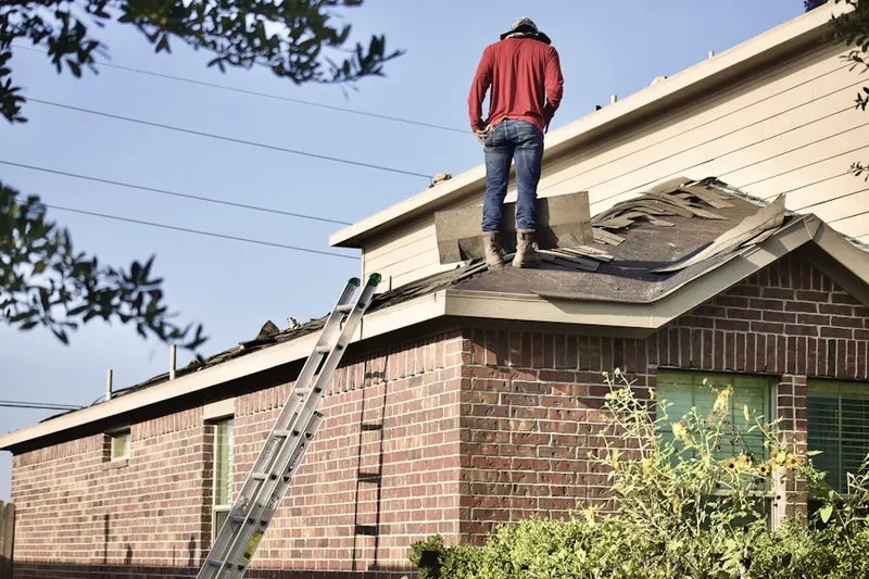 Professional roofer working on a residential roof in South Danville
